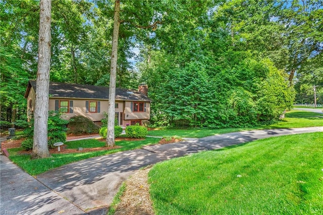 3228 Valley Rd, Winston-Salem, NC 27106 - bi-level home with a chimney, a front yard, and driveway