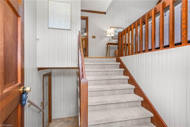 3228 Valley Rd, Winston-Salem, NC 27106 - stairway featuring brick patterned floors, wallpapered walls, and crown molding