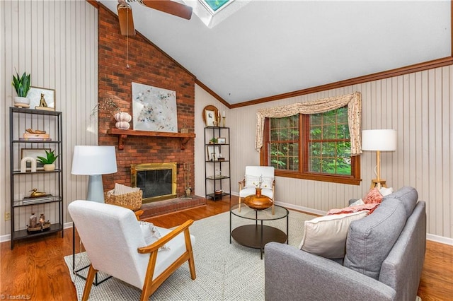 3228 Valley Rd, Winston-Salem, NC 27106 - living area featuring vaulted ceiling, wood finished floors, a fireplace, ceiling fan, and ornamental molding