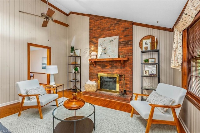 3228 Valley Rd, Winston-Salem, NC 27106 - living room with crown molding, lofted ceiling, wood finished floors, a brick fireplace, and ceiling fan