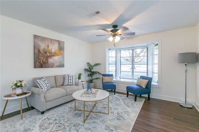 living room featuring ceiling fan and dark hardwood / wood-style floors