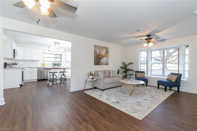 living room with dark hardwood / wood-style floors and ceiling fan