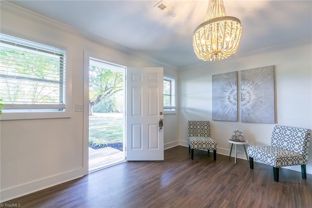 sitting room with crown molding, a chandelier, and dark hardwood / wood-style flooring