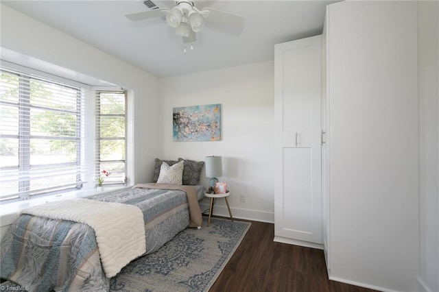 bedroom with ceiling fan and dark hardwood / wood-style flooring