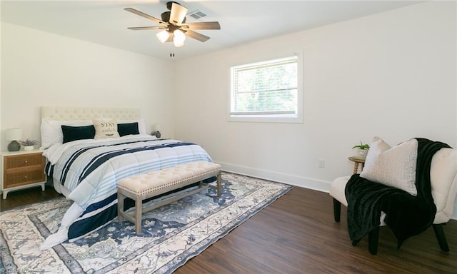 bedroom with dark hardwood / wood-style flooring and ceiling fan