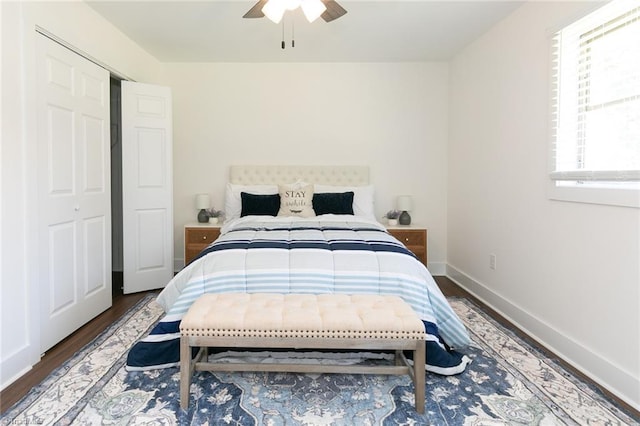 bedroom featuring ceiling fan, dark wood-type flooring, and a closet