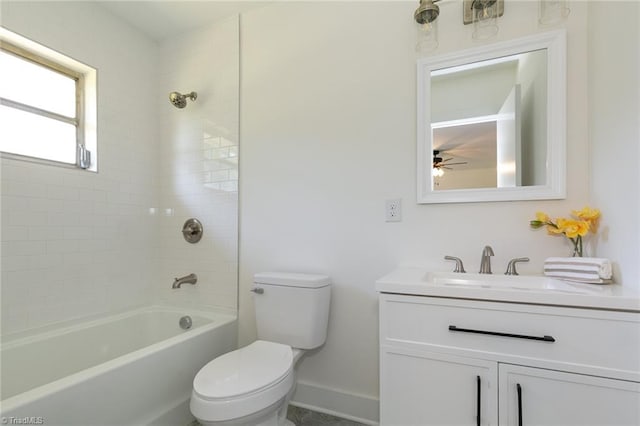 full bathroom featuring vanity, tiled shower / bath combo, and toilet