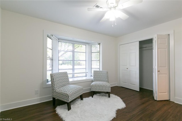 sitting room featuring dark hardwood / wood-style flooring and ceiling fan