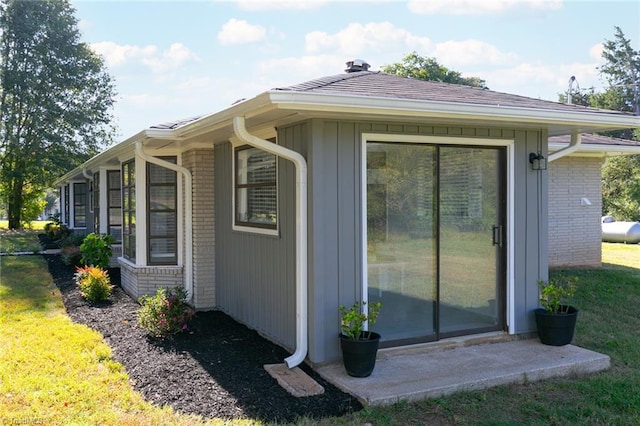 view of side of home featuring a yard