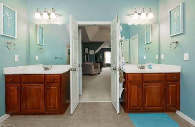 3704 Worthing Ct, Greensboro, NC 27455 - ensuite bathroom with two vanities, tile patterned flooring, and baseboards