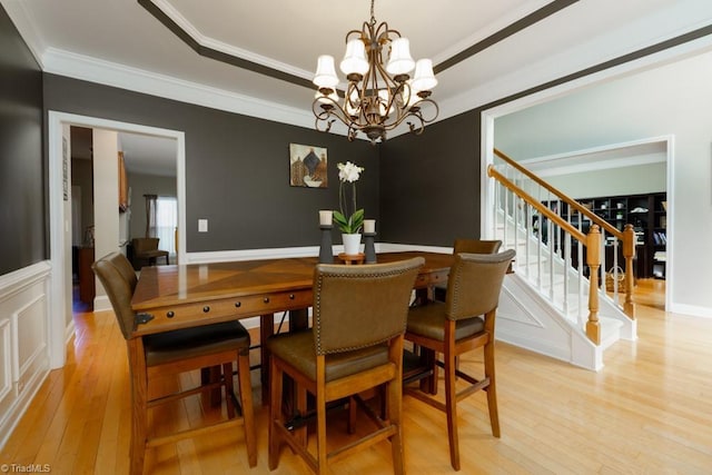 3704 Worthing Ct, Greensboro, NC 27455 - dining space with light wood-style flooring, stairs, a chandelier, ornamental molding, and a tray ceiling