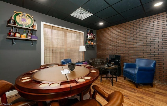 3704 Worthing Ct, Greensboro, NC 27455 - dining room featuring brick wall, wood finished floors, and a paneled ceiling