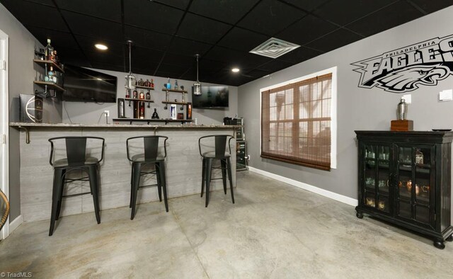 3704 Worthing Ct, Greensboro, NC 27455 - indoor wet bar featuring baseboards, concrete flooring, and a drop ceiling