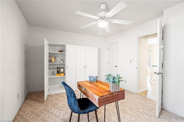 carpeted office featuring ceiling fan