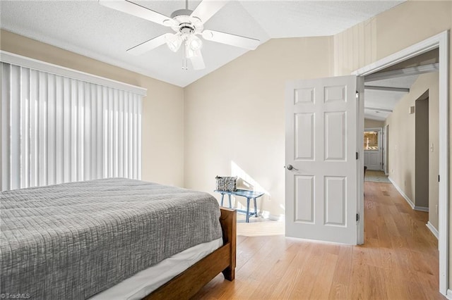 bedroom featuring vaulted ceiling, ceiling fan, and light wood-type flooring