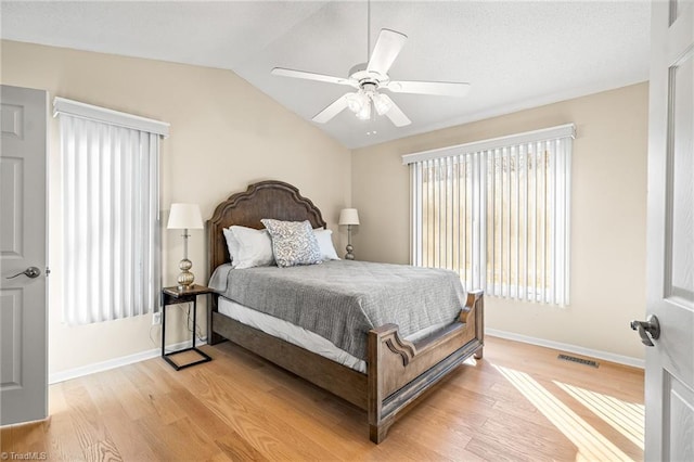 bedroom with vaulted ceiling, ceiling fan, and light hardwood / wood-style floors