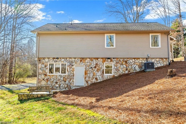 view of property exterior with a yard and central AC