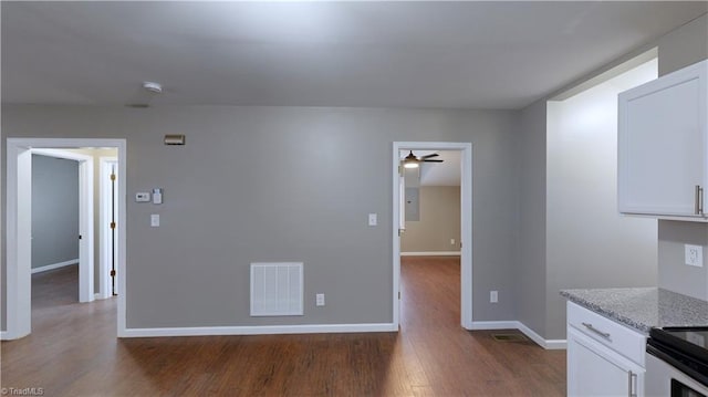 interior space featuring ceiling fan and dark hardwood / wood-style flooring