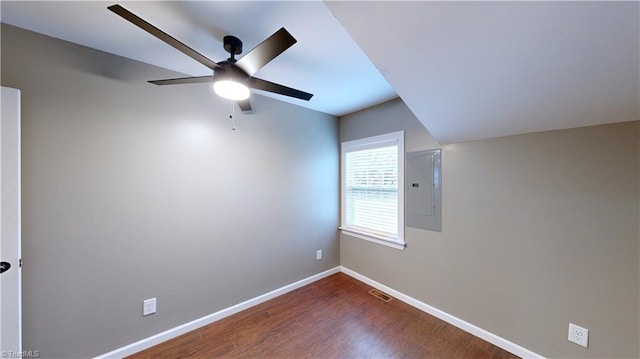 empty room with ceiling fan, dark hardwood / wood-style flooring, and electric panel