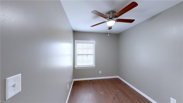 spare room featuring ceiling fan and dark wood-type flooring