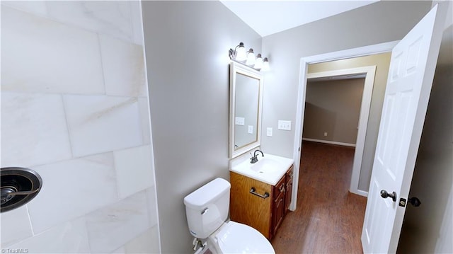 bathroom with hardwood / wood-style flooring, vanity, and toilet