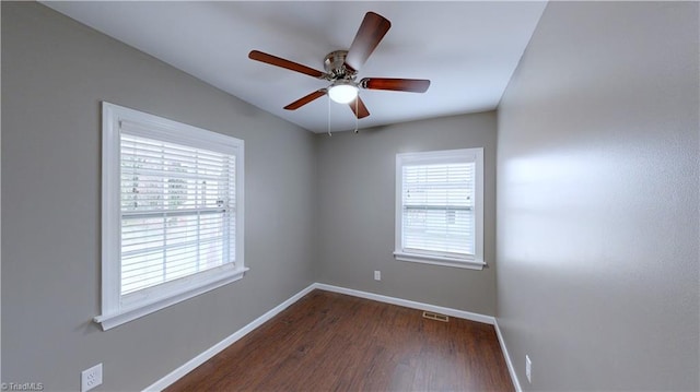 empty room featuring ceiling fan and dark wood-type flooring