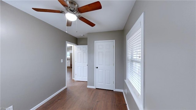 interior space with ceiling fan and dark hardwood / wood-style floors