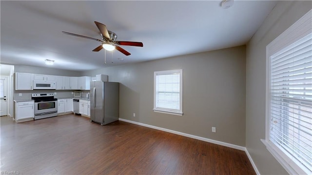 kitchen featuring ceiling fan, white cabinetry, dark wood-type flooring, and appliances with stainless steel finishes