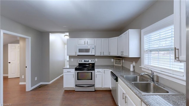 kitchen with white cabinets, stainless steel appliances, dark wood-type flooring, and sink