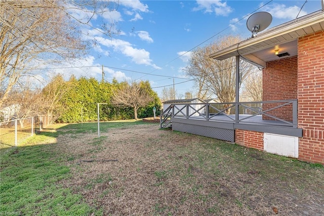 view of yard with fence and a deck