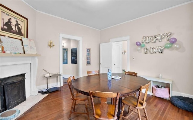 dining room featuring ornamental molding and hardwood / wood-style flooring