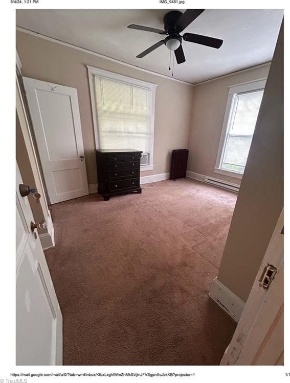 unfurnished bedroom featuring carpet flooring, a baseboard radiator, and ceiling fan