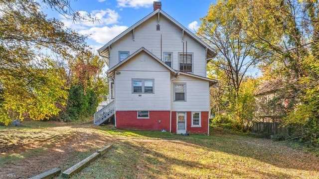 back of house with a lawn