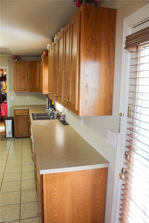 kitchen featuring light tile patterned flooring and sink