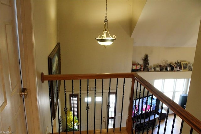 stairs featuring lofted ceiling and a healthy amount of sunlight