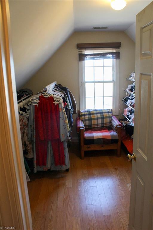 spacious closet with hardwood / wood-style flooring and lofted ceiling