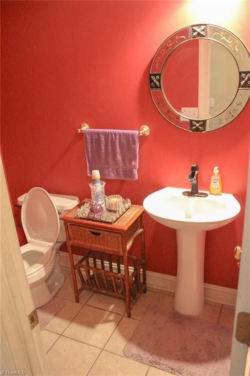 bathroom with tile patterned flooring and toilet