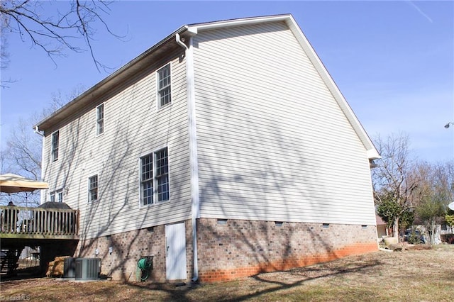 view of side of property with cooling unit and a deck