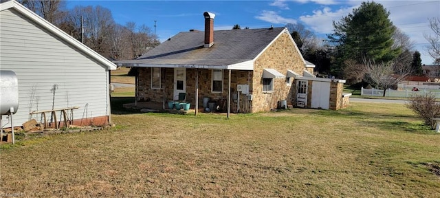 back of house featuring a yard