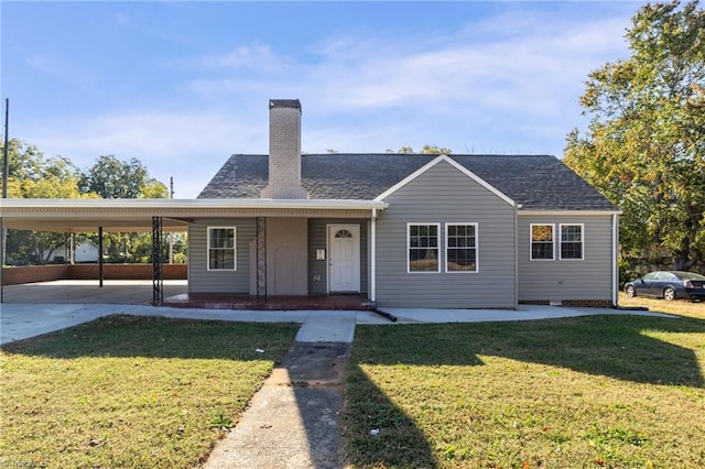 view of front of property with a front yard, covered porch, and a carport