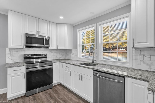 kitchen featuring sink, appliances with stainless steel finishes, crown molding, and white cabinets