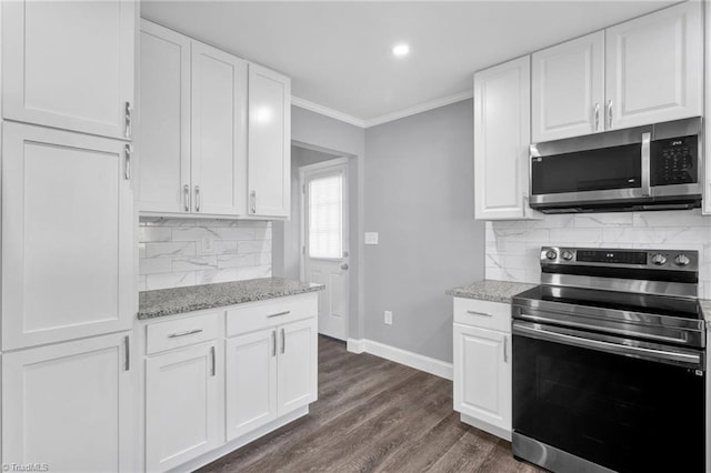 kitchen with white cabinetry, appliances with stainless steel finishes, ornamental molding, and dark wood-type flooring