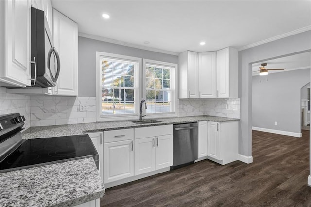 kitchen with white cabinetry, dark wood-type flooring, sink, crown molding, and stainless steel appliances