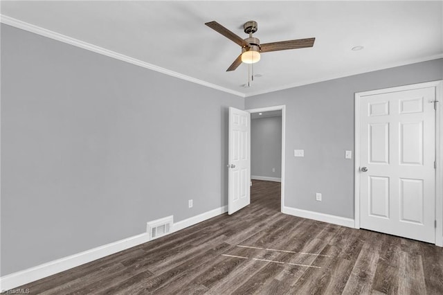 unfurnished bedroom with ceiling fan, crown molding, and dark hardwood / wood-style floors