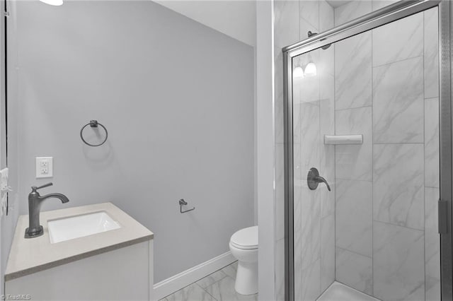 bathroom featuring a shower with door, toilet, and vanity