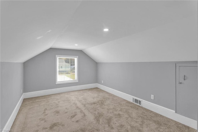 bonus room with lofted ceiling and carpet floors