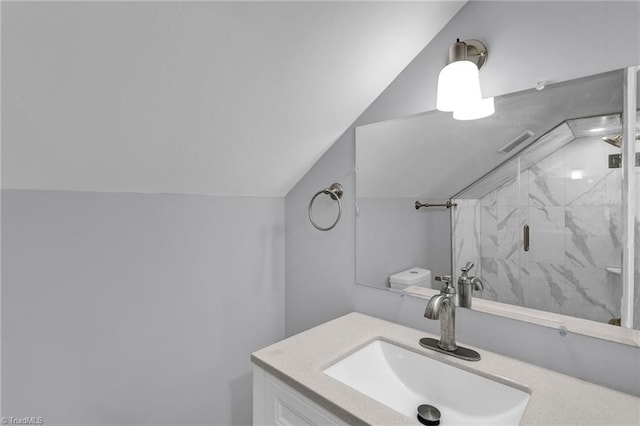 bathroom with vanity, walk in shower, and lofted ceiling