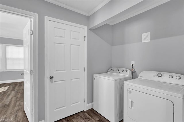 laundry room with independent washer and dryer, ornamental molding, and dark wood-type flooring