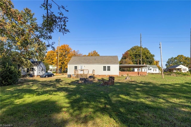 back of property featuring a yard and a carport