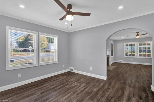 unfurnished room featuring ceiling fan, ornamental molding, and dark hardwood / wood-style floors